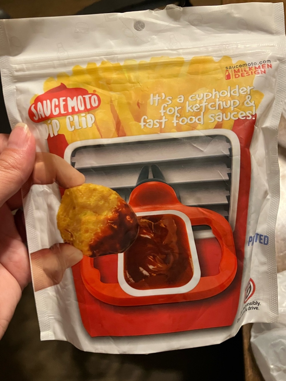 Saucemoto Dip Clip designed to hold fast food sauce containers